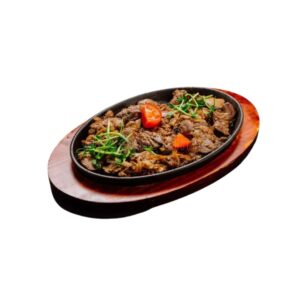 Beef Sizzling served hot on a platter with vegetables at City Cafe
