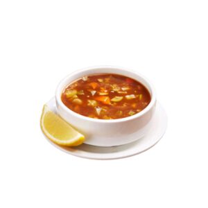 Hot and Sour Soup served at City Cafe in a ceramic bowl with fresh herbs