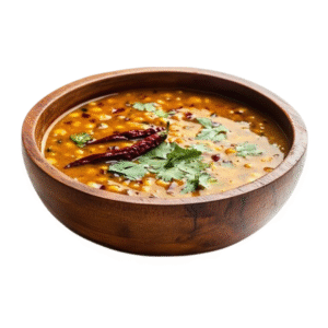 A bowl of creamy, yellow Mugdal from City Kebab & Cafe, garnished with coriander.